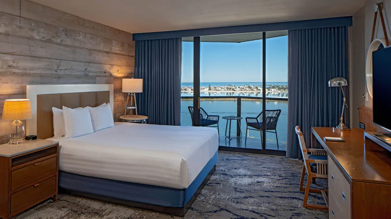 a hotel room with a view of the water and a bay