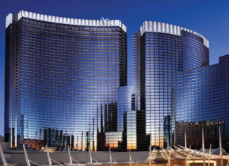 a group of tall buildings with a blue sky with Aria Resort and Casino in the background