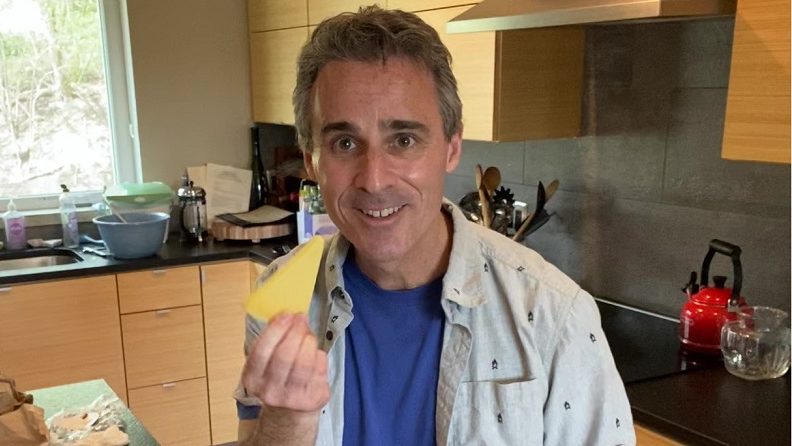 a man holding a piece of cheese