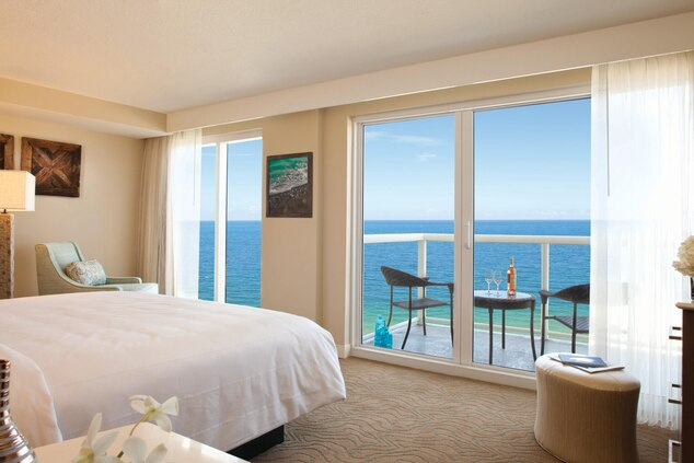 a bedroom with a view of the ocean