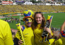 a couple of people in yellow and blue uniforms posing for a picture