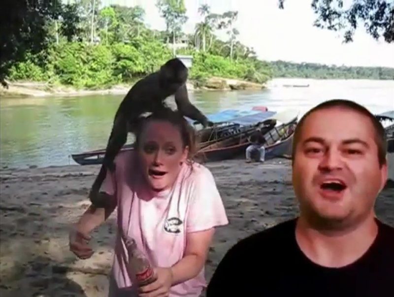 a man and woman with a monkey on their head