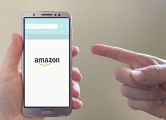 a person pointing at a cell phone