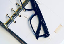 a pair of glasses on a notebook