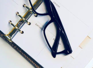a pair of glasses on a notebook