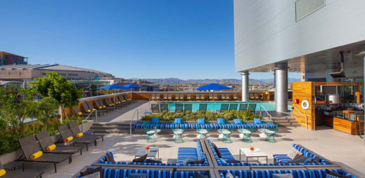 a pool with blue and white striped chairs and tables