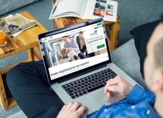 a person sitting on a couch using a laptop