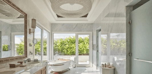 a bathroom with a tub and a large window