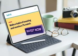 a tablet with a stylus and glasses on a table