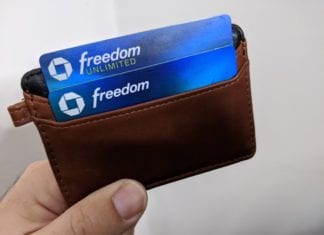 a hand holding a wallet with credit cards