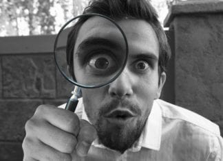 a man holding a magnifying glass