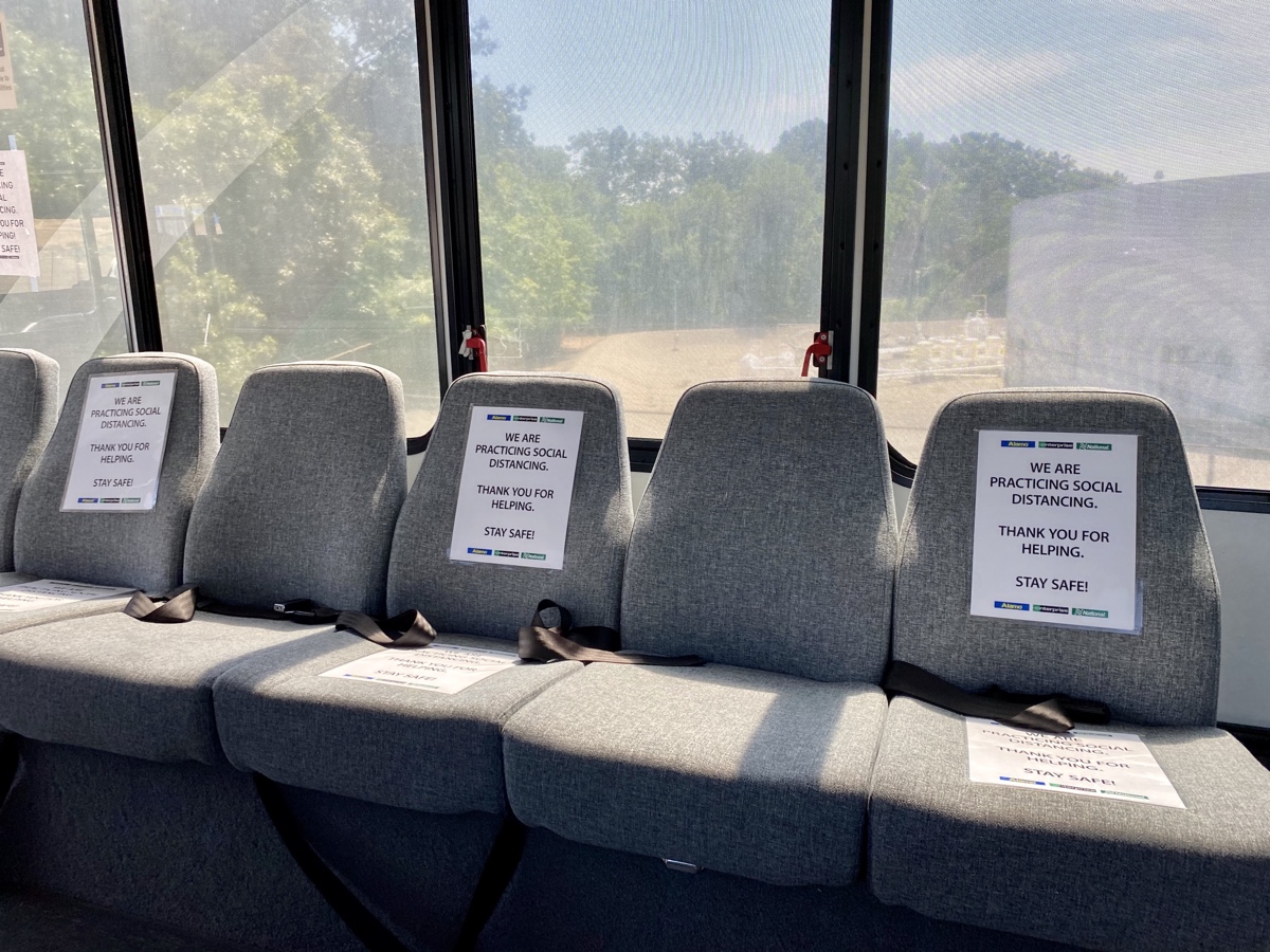 a row of grey seats with signs on them