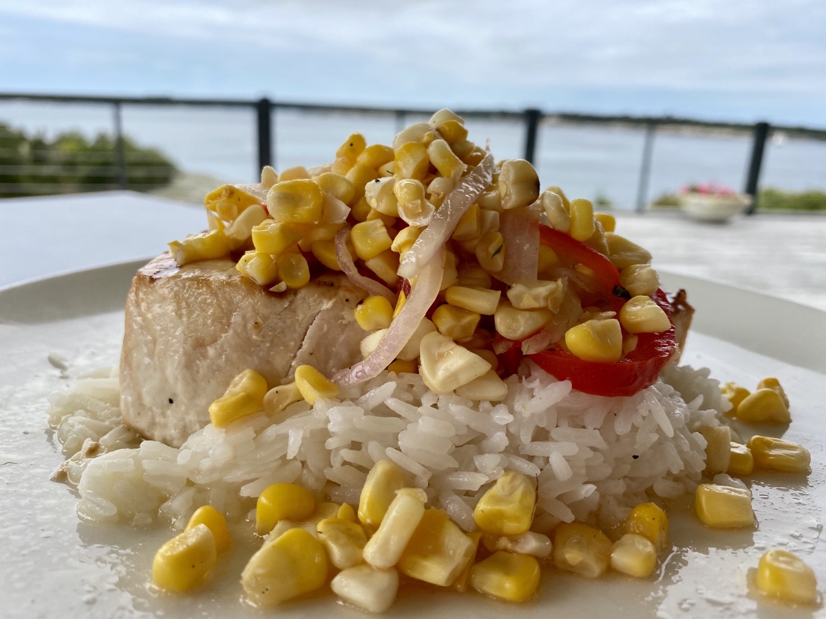 a plate of food with rice and corn