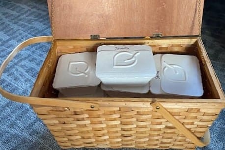 a basket with white containers in it