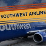 a blue airplane on a runway