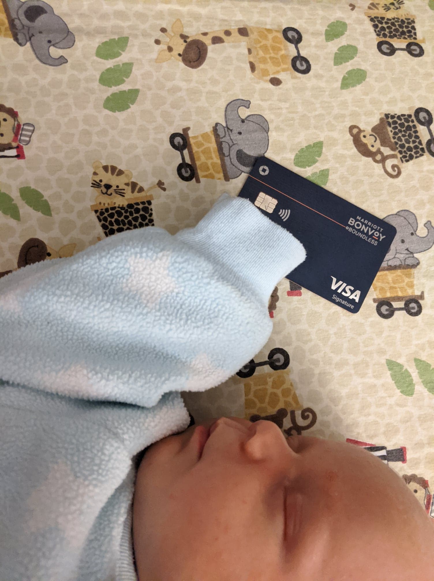 a baby sleeping with a credit card