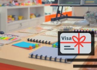 a desk with notebooks and a logo