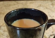 a black mug with a liquid in it