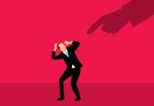 a man in a suit and tie holding his head