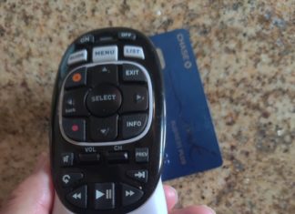 a hand holding a remote control