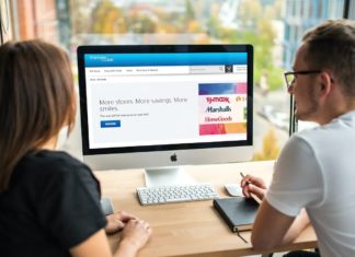 a man and woman looking at a computer screen