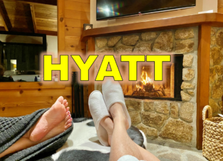 a pair of feet in slippers by a fireplace