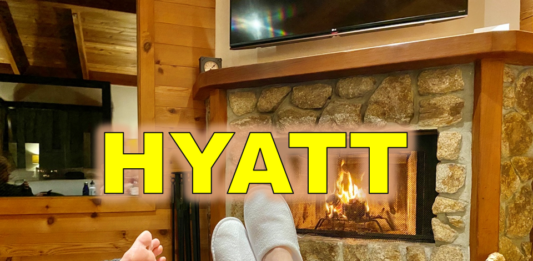 a pair of feet in slippers by a fireplace