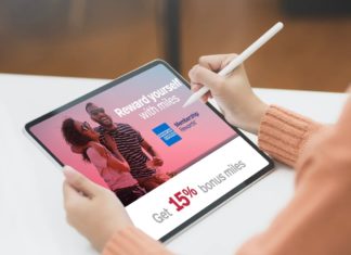 a person holding a stylus and a tablet