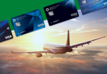a plane flying in the sky with credit cards