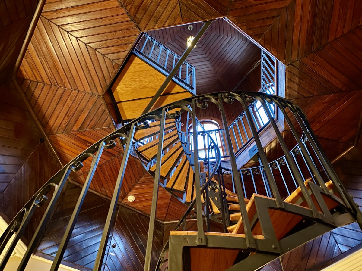 a spiral staircase in a wood room