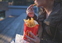 a woman eating french fries