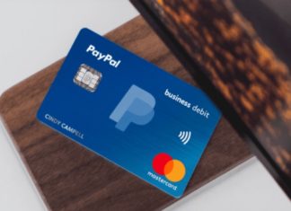a blue credit card on a wood surface