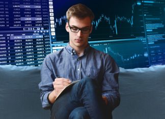 a man sitting on a couch writing on a notepad