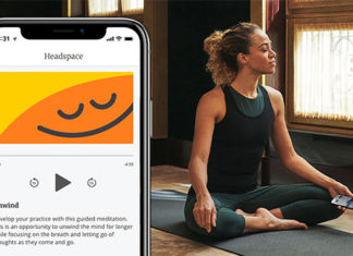 a woman sitting on a yoga mat and a phone