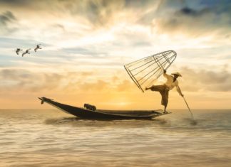 a man in a boat with a fishing net