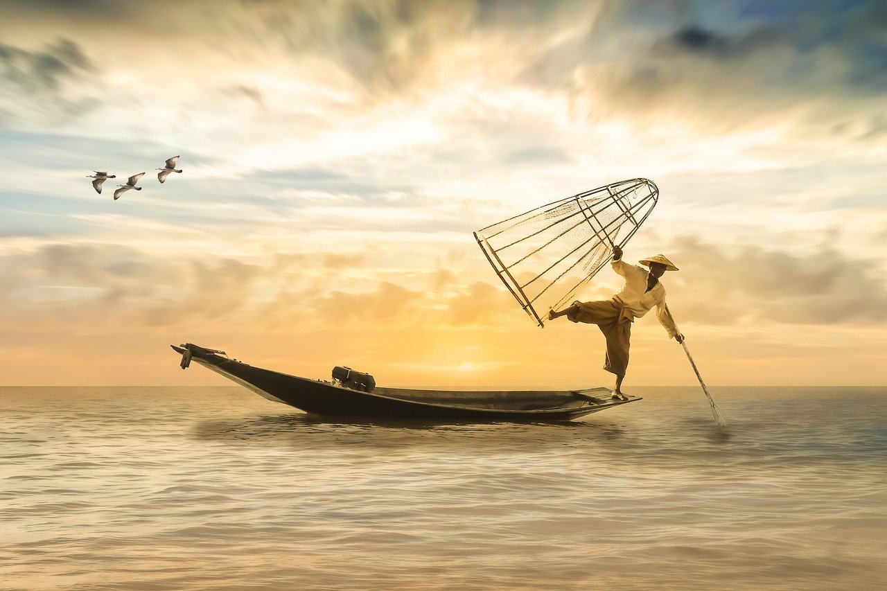 a man in a boat with a fishing net