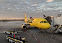 a yellow airplane at an airport