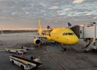 a yellow airplane at an airport