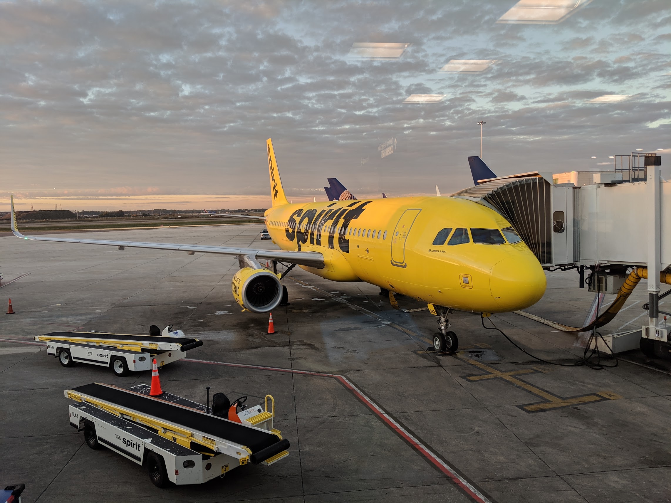 a yellow airplane at an airport
