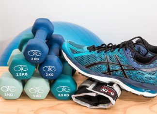 a pair of blue sneakers and weights