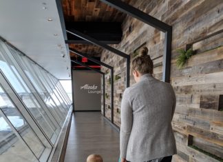 a woman and a baby walking down a hallway