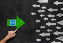 a hand pointing at a green arrow pointing at a green arrow