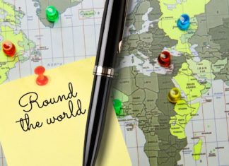 a pen and a map with push pins