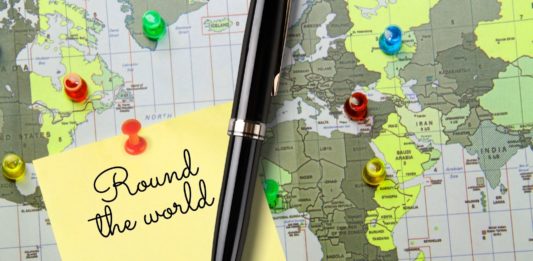 a pen and a map with push pins