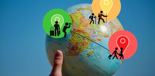 a hand holding a globe