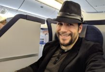 a man wearing a hat and sitting in an airplane