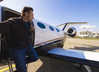 a man climbing into a small airplane