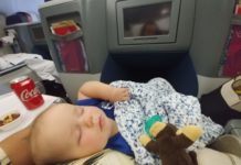 a baby sleeping on a plane