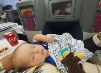 a baby sleeping on a plane