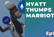 a man in a suit jumping in the air with a shoe in the air